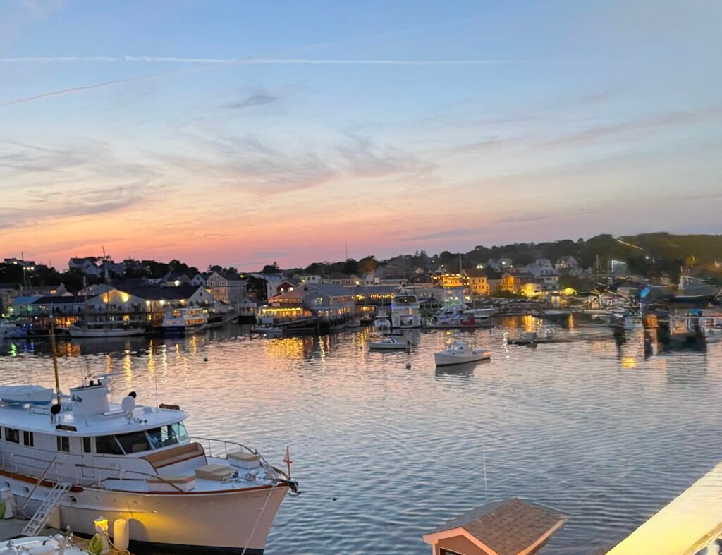 Luxury yachts and boats anchored in a harbor during a golden sunset